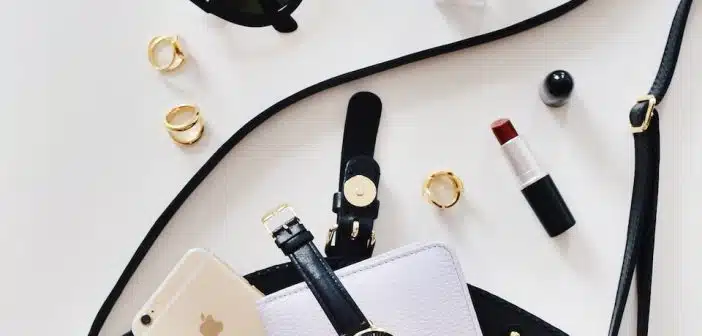 women's sunglasses and black bag with watch and iPhone 6