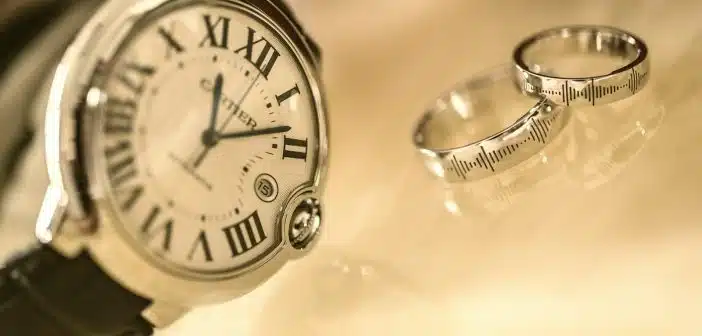 silver-colored analog watch near two silver-colored rings